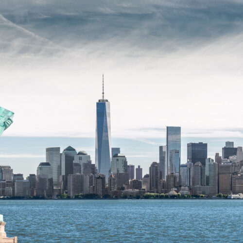 The,Statue,Of,Liberty,With,One,World,Trade,Center,Background,